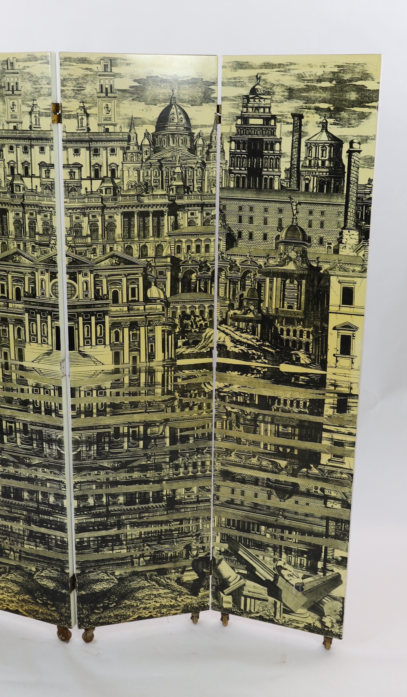 Piero Fornasetti (Italian, 1913-1988) - ‘’Citta Che Si Rispecchia’’ [City that reflects itself] four panel screen width of each section 50cm height without castors 200cm